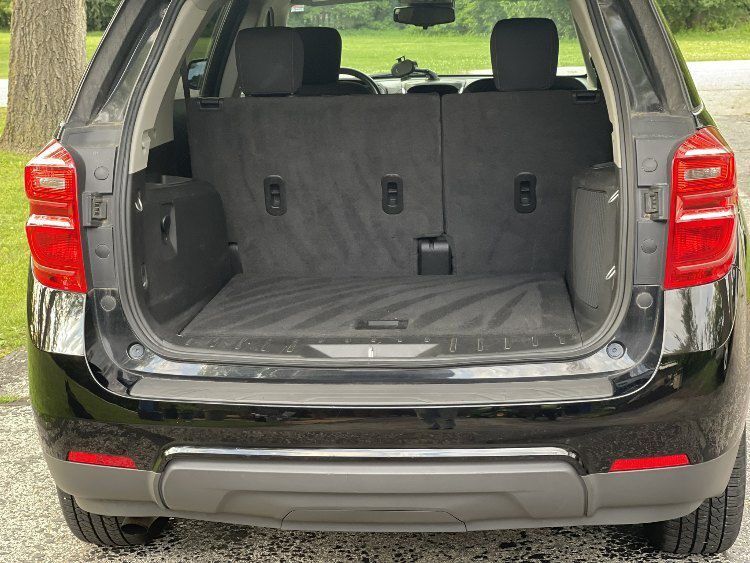 Interior view of a clean Chevrolet Equinox showcasing detailed rear seating area and cargo space, emphasizing meticulous cleaning and maintenance services offered by On Demand Detailing for enhanced vehicle aesthetics and air quality.