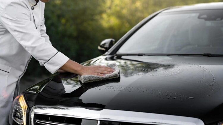 Luxury vehicle receiving mobile ceramic coating service for optimal paint protection and shine